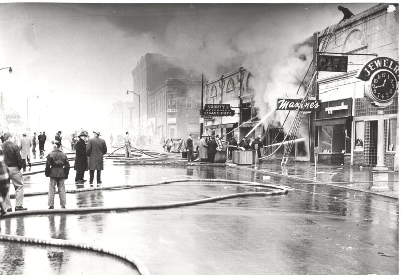 item thumbnail for Firefighters spraying water on a blaze on Main Street with fire hoses. the fire broke out between 2nd and 3rd streets between Shorty's and Maxine's.