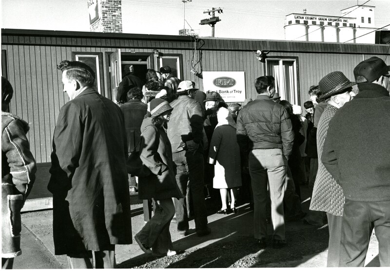 item thumbnail for People waiting outside trailer office of First Bank of Troy